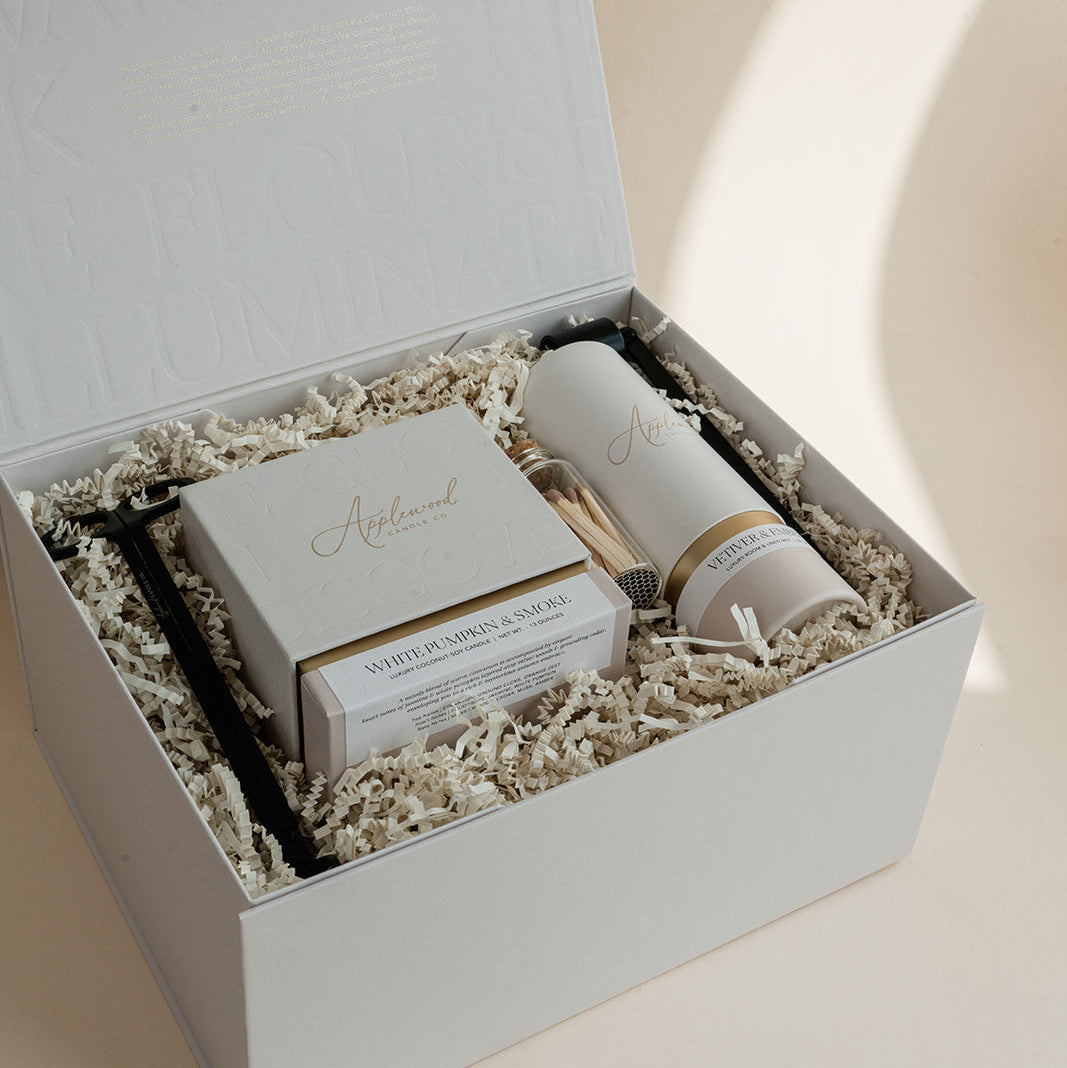 Luxury custom gift box with White Pumpkin & Smoke candle, Vetiver and Ember Moss room linen & mist, candle snuffer, wick trimmer and set of matches.
