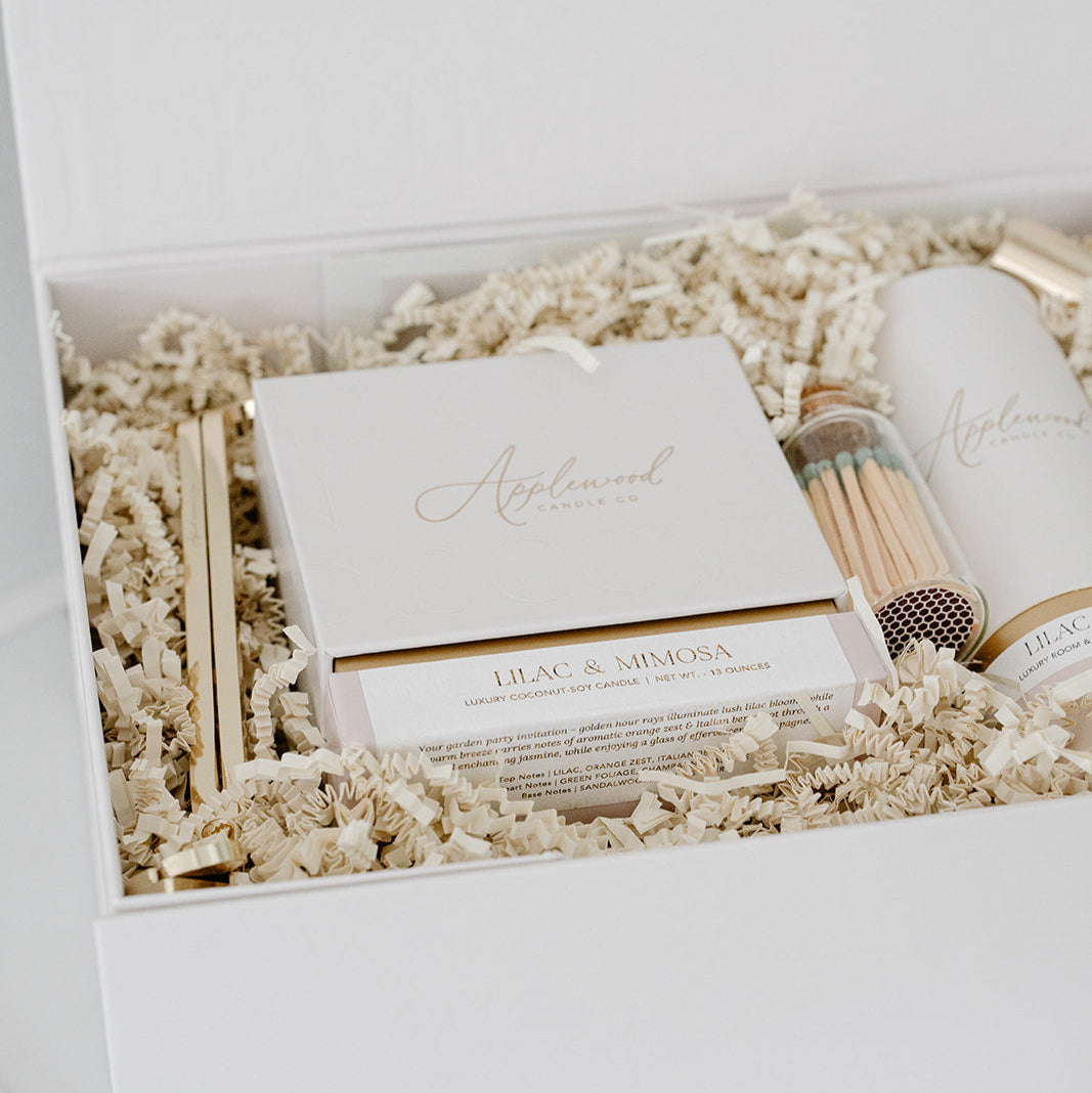 Luxury Lilac & Mimosa candle on gift box with room & linen mist, candle snuffer, wick trimmer, and matches