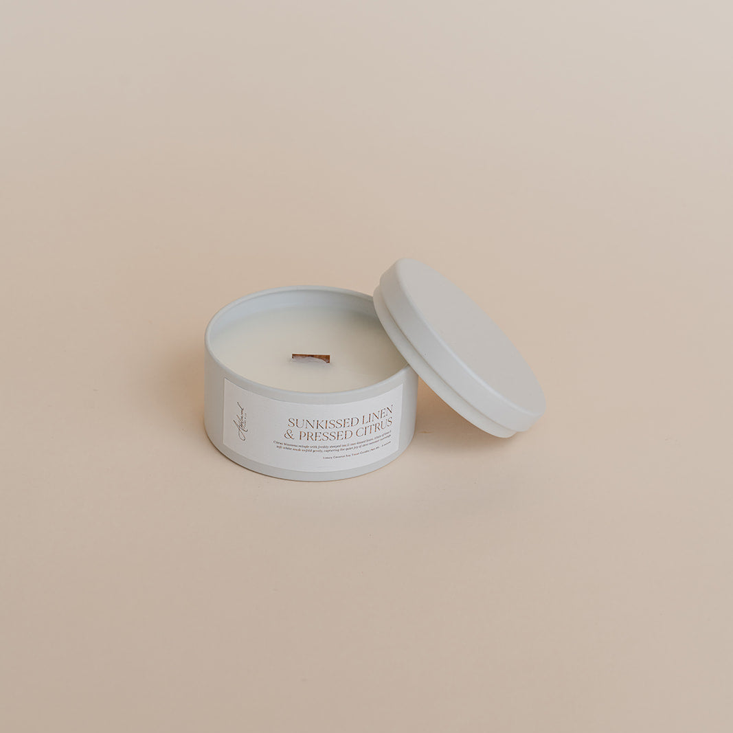Candle in a white container with a beige background