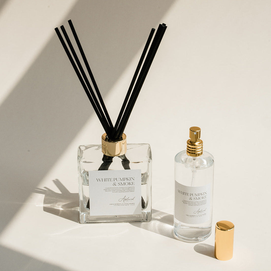 Diffuser with reeds and a small bottle on a light background