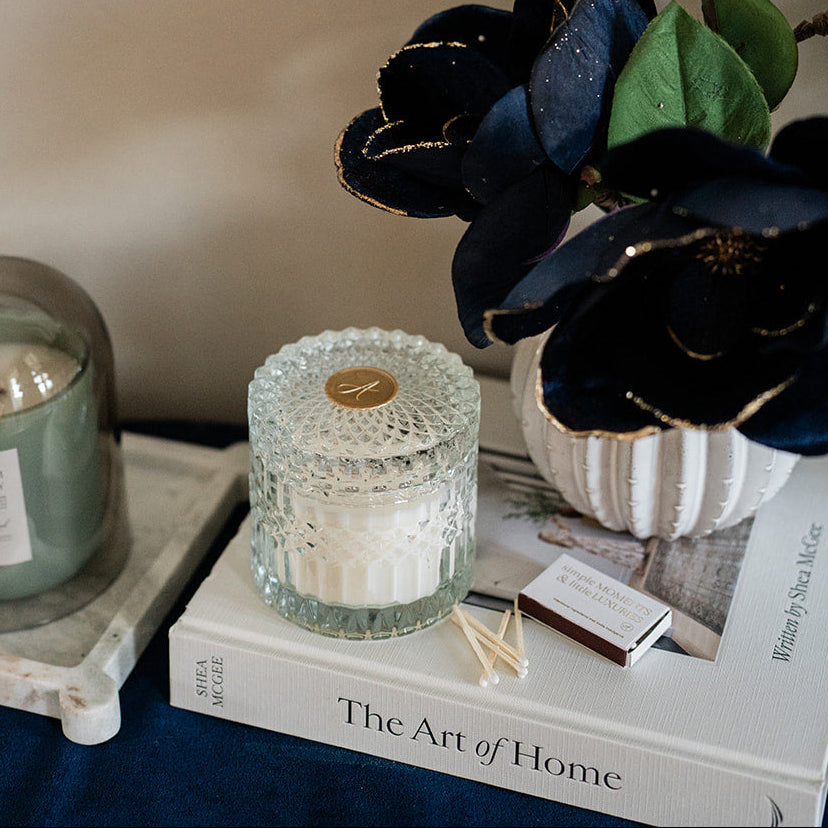 Decorative setup with candles, flowers, and a framed photo on a surface.