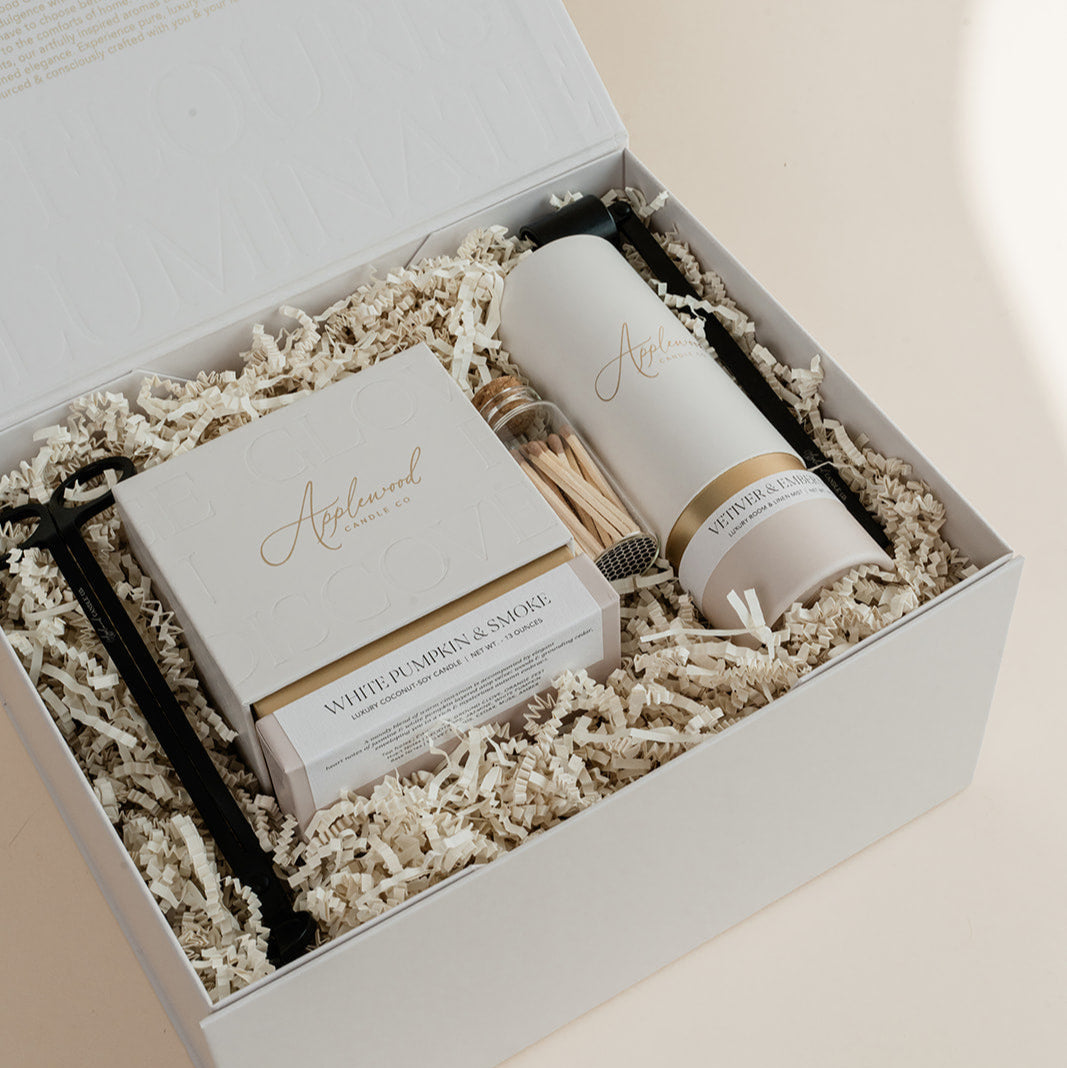 Luxury custom gift box with White Pumpkin & Smoke candle, Vetiver and Ember Moss room linen & mist, candle snuffer, wick trimmer and set of matches.