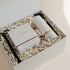 Luxury custom gift box with White Pumpkin & Smoke candle, Vetiver and Ember Moss room linen & mist, candle snuffer, wick trimmer and set of matches.