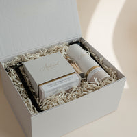 Luxury custom gift box with White Pumpkin & Smoke candle, Vetiver and Ember Moss room linen & mist, candle snuffer, wick trimmer and set of matches.