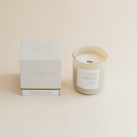 Cashmere & Vanilla candle in frosted glass jar with box on beige background.