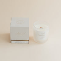 Citrus Grove candle in frosted glass jar with box on beige background.