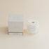 Citrus Grove candle in frosted glass jar with box on beige background.