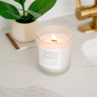 Lit Grapefruit & Mint Leaves candle in glass frosted jar
