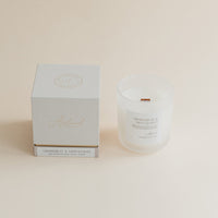 Grapefruit & Mint Leaves candle in frosted glass jar with box on beige background.