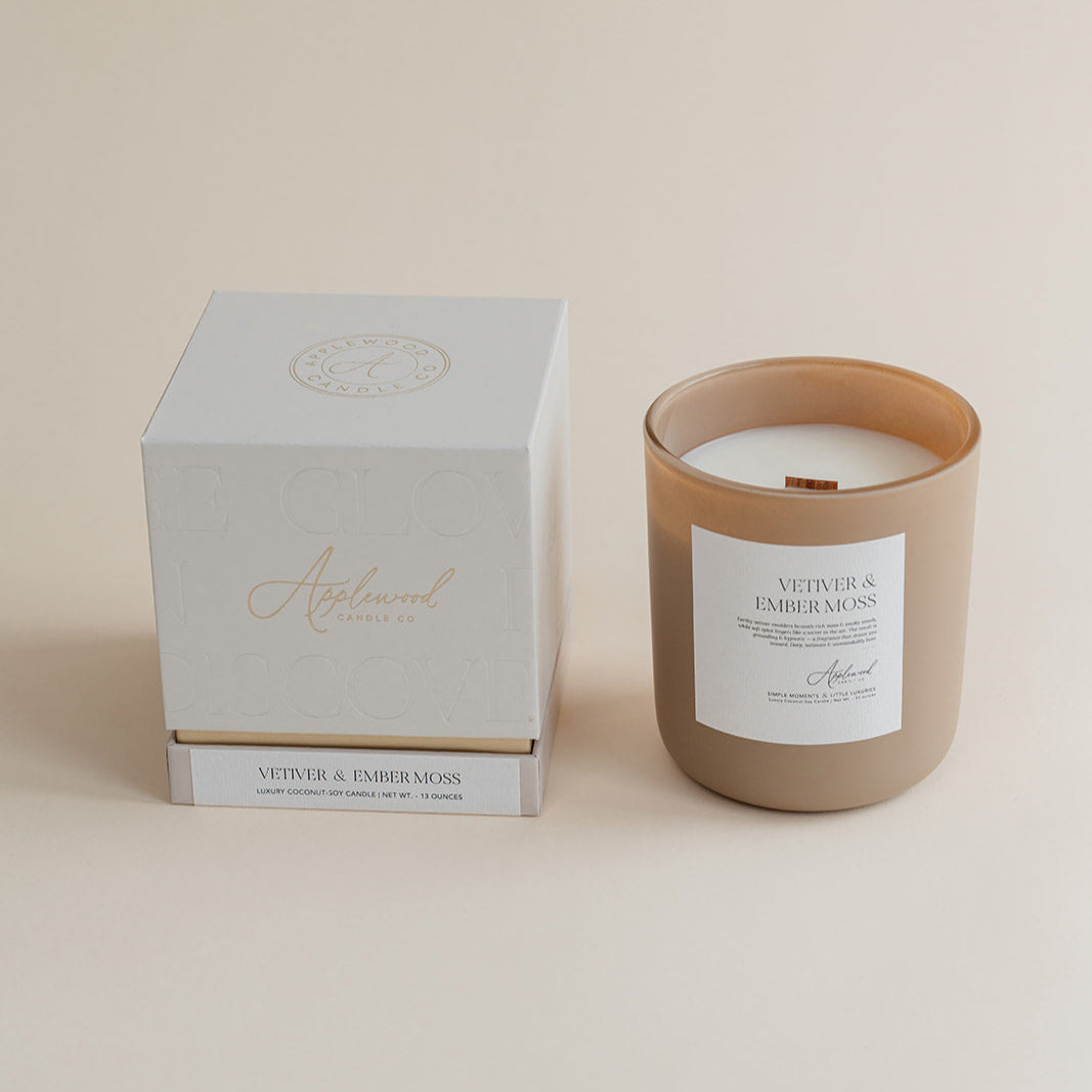Luxury Vetiver & Ember Moss candle with box on beige backgound