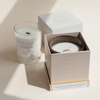 Antique Leather & Cognac candle in clear glass jar with open luxury candle box.