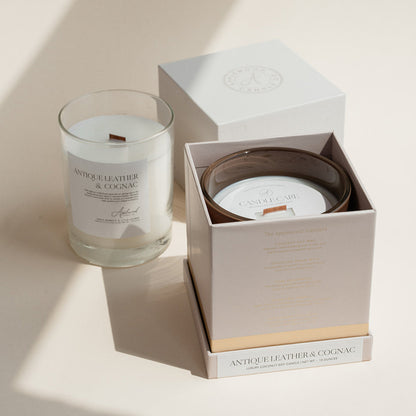 Antique Leather &amp; Cognac candle in clear glass jar with open luxury candle box.