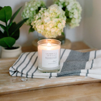 Lit Grapefruit  & Mint Leaves candle in glass jar 
