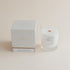 Vetiver & Ember Moss signature candle with box on beige background