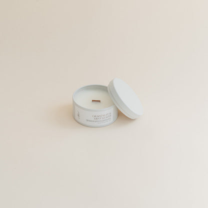 Travel Grapefruit &amp; Mint Leaves candle in tin can on beige background.