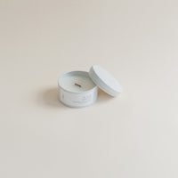 Travel Lilac & Mimosa candle in tin can on beige background