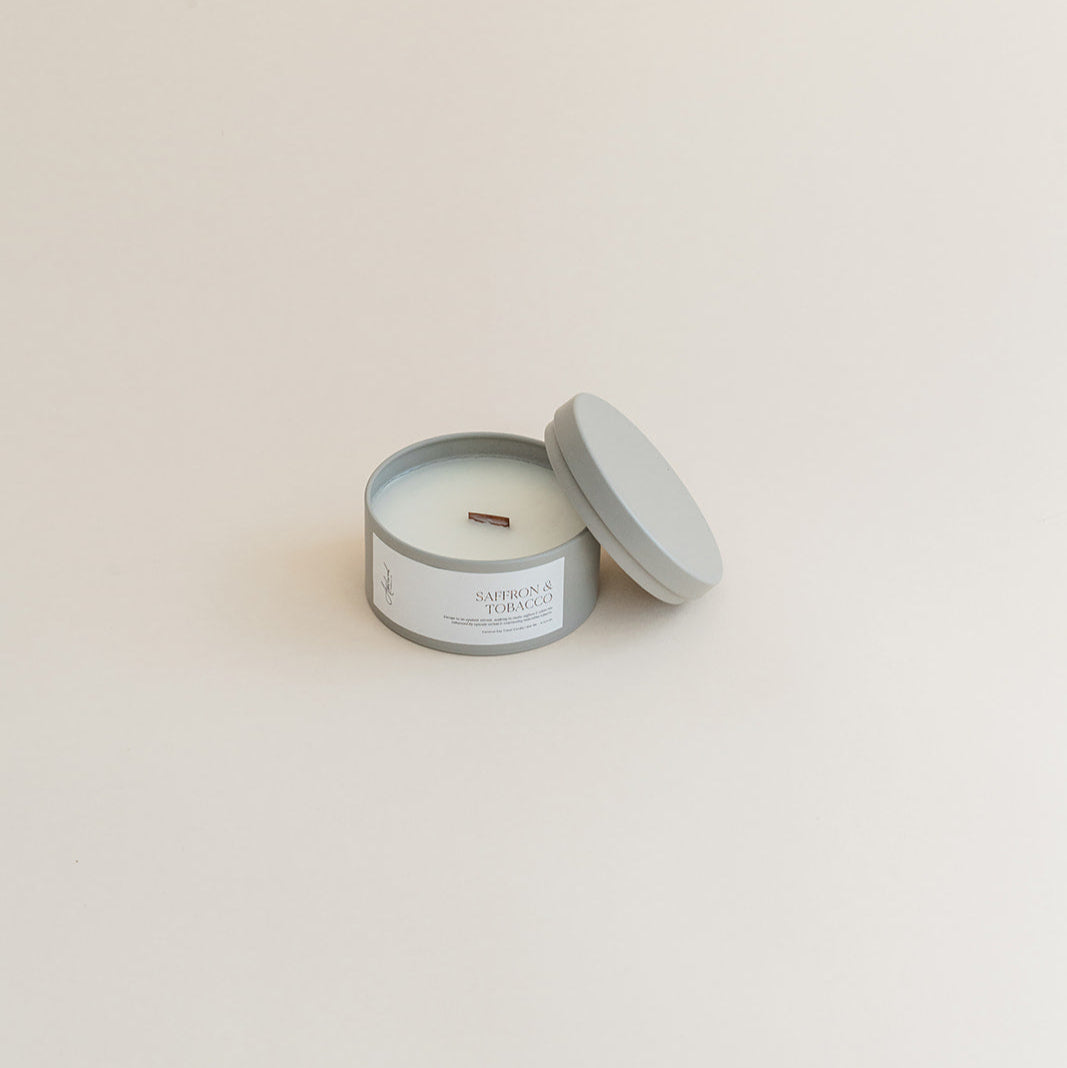Travel Saffron &amp; Tobacco candle in tin can on beige background
