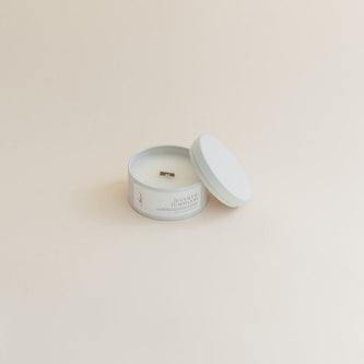 Travel Sea Salt & Teakwood candle in tin can on beige background