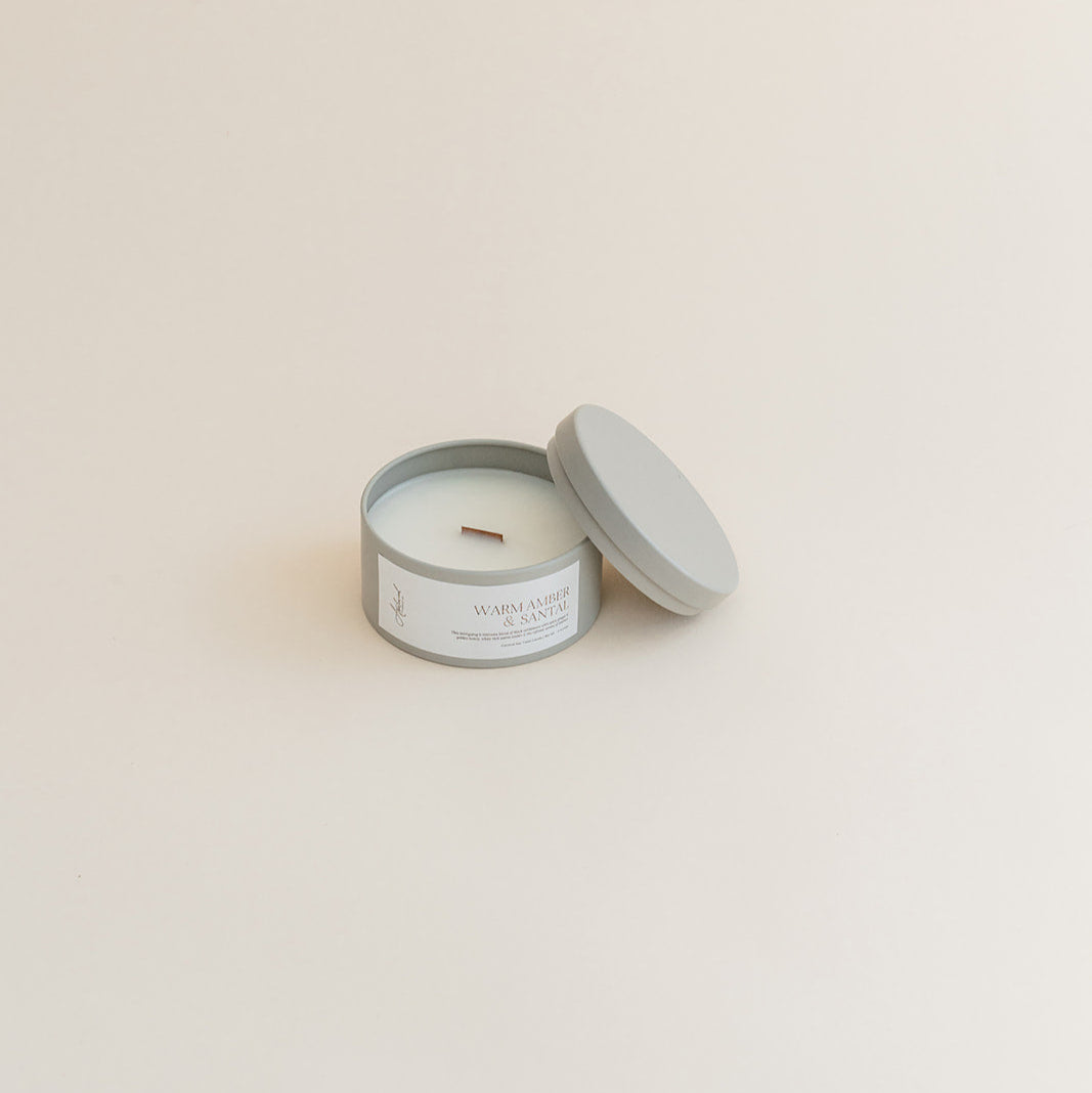 Warm Amber &amp; Santal travel candle on beige backdrop