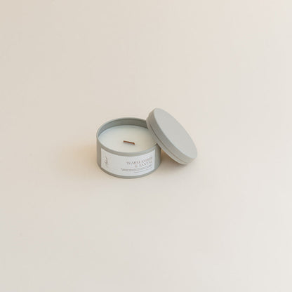 Warm Amber &amp; Santal travel candle on beige backdrop