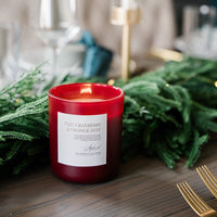 Scarlett colored candle vessel styled with greenery 