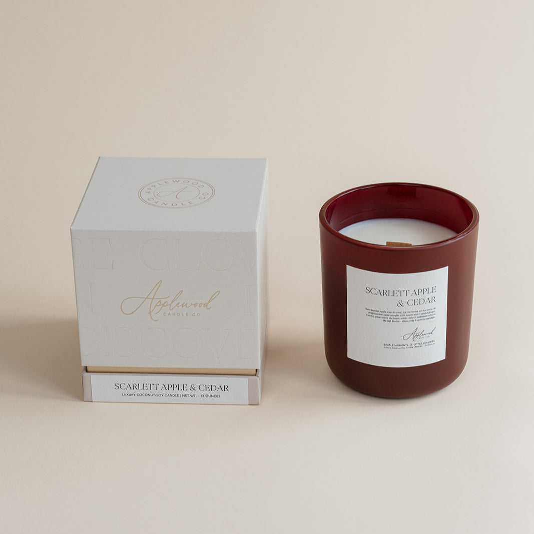 Candle with a matching box on a beige background