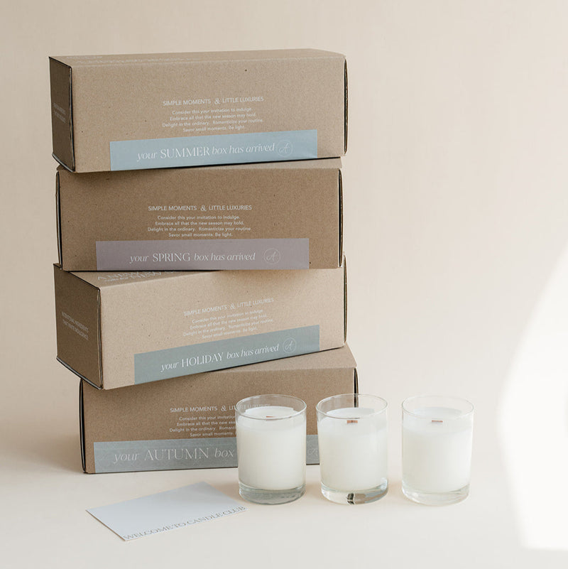 Stack of boxes with candles on a neutral background