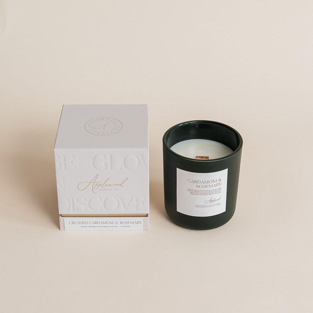 Black candle in a box on a beige background